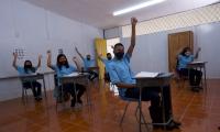 Varios estudiantes con mascarilla en un aula